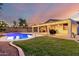 Beautiful backyard with in-ground pool, desert landscaping, and outdoor lights at 14687 W Amelia Ave, Goodyear, AZ 85395