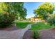 Backyard features a built-in kitchen and sand volleyball court at 14687 W Amelia Ave, Goodyear, AZ 85395
