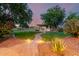 Manicured backyard with custom brick path and built in outdoor entertaining area at 14687 W Amelia Ave, Goodyear, AZ 85395