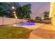 Backyard with in-ground pool, and outdoor lights at 14687 W Amelia Ave, Goodyear, AZ 85395