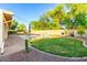 Backyard featuring grass and a pool with brick trimming at 14687 W Amelia Ave, Goodyear, AZ 85395