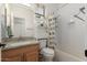 Cozy bathroom with updated vanity, neutral tile, tub, and shower at 14687 W Amelia Ave, Goodyear, AZ 85395