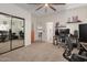 Versatile room features large closet, ceiling fan, and office setup, ideal for work or relaxation at 14687 W Amelia Ave, Goodyear, AZ 85395