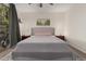 Comfortable bedroom with a plush rug, soft lighting, neutral paint and a ceiling fan at 14687 W Amelia Ave, Goodyear, AZ 85395