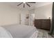 Relaxing bedroom featuring neutral tones, a ceiling fan, and a spacious closet for organized living at 14687 W Amelia Ave, Goodyear, AZ 85395