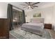 Calm main bedroom with sliding glass doors and neutral decor plus ceiling fan at 14687 W Amelia Ave, Goodyear, AZ 85395