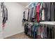 Well-organized walk-in closet provides ample storage space for clothing and accessories in a clean and efficient design at 14687 W Amelia Ave, Goodyear, AZ 85395