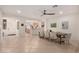Inviting dining room with tile flooring, modern light fixture, and adjacent kitchen access at 14687 W Amelia Ave, Goodyear, AZ 85395