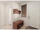 Welcoming entryway with tile flooring, coat rack, shoe storage bench, and natural light at 14687 W Amelia Ave, Goodyear, AZ 85395