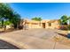 Attractive modern home with a three-car garage, ample driveway space, and desert landscaping at 14687 W Amelia Ave, Goodyear, AZ 85395