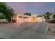 Beautiful desert home with three-car garage, ample driveway space, and manicured landscaping at 14687 W Amelia Ave, Goodyear, AZ 85395