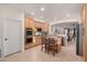 Modern kitchen featuring natural wood cabinets, granite counters, stainless steel appliances, and an island with seating at 14687 W Amelia Ave, Goodyear, AZ 85395
