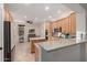 Well-appointed kitchen featuring granite countertops, stainless appliances, and natural wood cabinetry at 14687 W Amelia Ave, Goodyear, AZ 85395