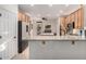 Modern kitchen featuring natural wood cabinets, granite counters, and stainless steel appliances including a double oven at 14687 W Amelia Ave, Goodyear, AZ 85395