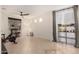Bright and airy living room with tile floors, large windows, and a ceiling fan at 14687 W Amelia Ave, Goodyear, AZ 85395