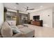 Cozy living room featuring a comfortable sectional sofa, entertainment center, and sliding glass doors to the patio at 14687 W Amelia Ave, Goodyear, AZ 85395
