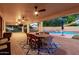 Outdoor patio space with dining area, seating and backyard pool at 14687 W Amelia Ave, Goodyear, AZ 85395