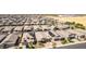 Aerial view of a residential neighborhood with neutral-toned homes and open land at 15078 W Mckinley St, Goodyear, AZ 85338