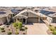 An aerial view of the attractive neighborhood, desert landscaping, and paved driveway at 15078 W Mckinley St, Goodyear, AZ 85338