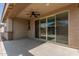 Covered back patio with ceiling fan and sliding glass doors at 15078 W Mckinley St, Goodyear, AZ 85338