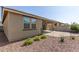 A private backyard featuring gravel, a covered patio, and desert landscaping at 15078 W Mckinley St, Goodyear, AZ 85338