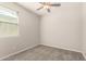 Neutral bedroom featuring soft carpet, ceiling fan, and a window with natural light at 15078 W Mckinley St, Goodyear, AZ 85338