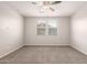 Bedroom featuring carpet, ceiling fan, and two windows with blinds at 15078 W Mckinley St, Goodyear, AZ 85338