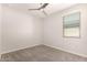 Light and airy bedroom boasts neutral tones, a ceiling fan and a bright window at 15078 W Mckinley St, Goodyear, AZ 85338