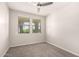 Bedroom featuring carpet, ceiling fan, and two windows with blinds at 15078 W Mckinley St, Goodyear, AZ 85338
