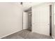 Cozy bedroom features gray carpet, closet with paneled doors and an adjacent entrance at 15078 W Mckinley St, Goodyear, AZ 85338