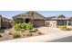 Attractive exterior with desert landscaping, a paved driveway and a two car garage at 15078 W Mckinley St, Goodyear, AZ 85338