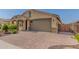 Inviting home exterior with a brick-paved driveway and a two-car garage at 15078 W Mckinley St, Goodyear, AZ 85338