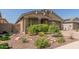 Charming home exterior featuring professionally landscaped front yard with desert plants and rocks at 15078 W Mckinley St, Goodyear, AZ 85338