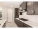 Modern kitchen featuring stainless steel appliances, dark cabinets, and a white backsplash at 15078 W Mckinley St, Goodyear, AZ 85338