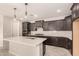 Well-designed kitchen with an island, modern appliances, and dark cabinetry at 15078 W Mckinley St, Goodyear, AZ 85338