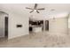 Spacious living area open to kitchen, featuring stylish tile flooring and neutral tones at 15078 W Mckinley St, Goodyear, AZ 85338
