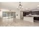 Bright, open-concept living space with sliding glass doors and views into the kitchen at 15078 W Mckinley St, Goodyear, AZ 85338