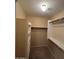Walk-in closet equipped with shelves and wooden racks for optimal storage solutions at 16126 N 159Th Dr, Surprise, AZ 85374
