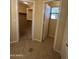 Hallway featuring tile flooring, leading to a closet and another room with a window at 16126 N 159Th Dr, Surprise, AZ 85374