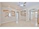 Open-concept living room featuring laminate flooring, stylish built-in shelving, and lots of natural light at 16126 N 159Th Dr, Surprise, AZ 85374