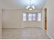 Spacious living room with tile flooring, large windows, and a modern chandelier at 16126 N 159Th Dr, Surprise, AZ 85374