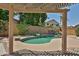 Inviting backyard pool featuring a rock waterfall and mature desert landscaping, perfect for relaxation at 16126 N 159Th Dr, Surprise, AZ 85374