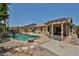 The backyard of the home featuring a kidney-shaped pool, rock waterfall and pergola covered patio at 16126 N 159Th Dr, Surprise, AZ 85374