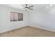 Bright bedroom featuring a ceiling fan, light-colored walls, and wood-look flooring at 1631 E Newport Dr, Tempe, AZ 85282