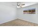 Well-lit bedroom with neutral paint, wood-look flooring and a large window at 1631 E Newport Dr, Tempe, AZ 85282