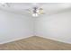 This bedroom features neutral walls, wood-look flooring, and a ceiling fan at 1631 E Newport Dr, Tempe, AZ 85282