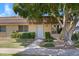 Quaint single-story home with a mature shade tree and lush green lawn at 1631 E Newport Dr, Tempe, AZ 85282