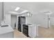 Modern kitchen with quartz counters, stainless appliances and adjacent laundry room at 1631 E Newport Dr, Tempe, AZ 85282