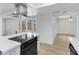 Updated kitchen with modern range and hood with french doors leading to backyard at 1631 E Newport Dr, Tempe, AZ 85282