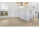 Bright living room with light wood flooring, ceiling fan and a view to the outdoor landscape at 1631 E Newport Dr, Tempe, AZ 85282